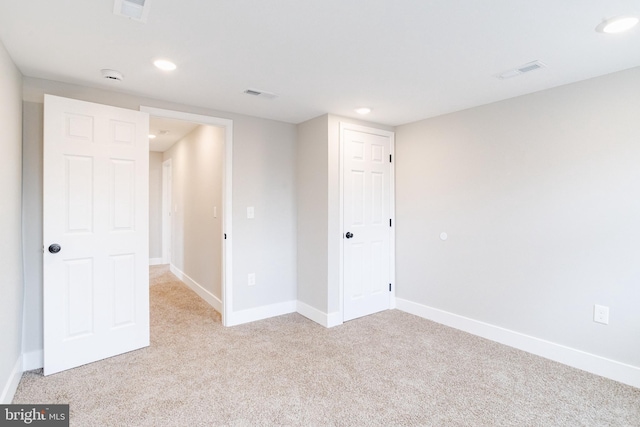 unfurnished bedroom with light colored carpet