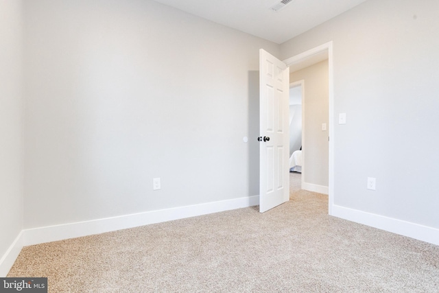 empty room with light colored carpet