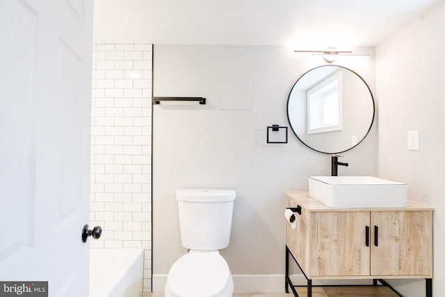 full bathroom with vanity, toilet, and tiled shower / bath combo