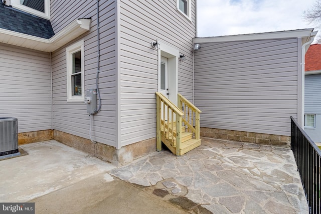 property entrance with central AC unit and a patio area