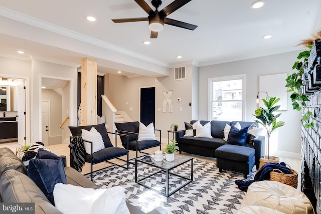 living room with ceiling fan and ornamental molding