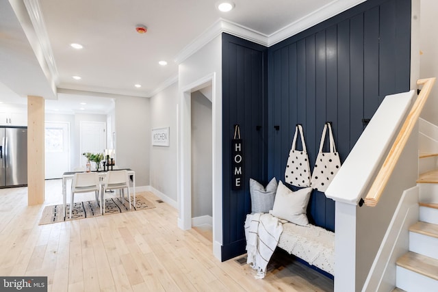 mudroom featuring crown molding and light wood-type flooring