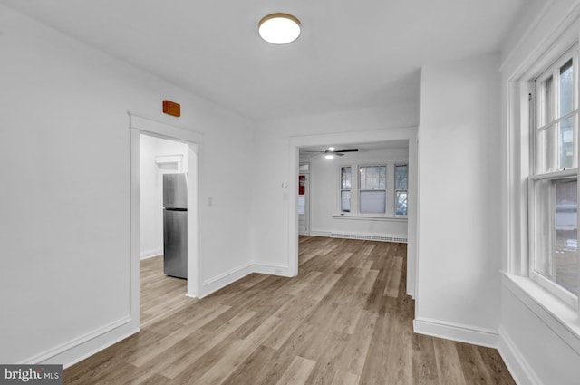 interior space with light hardwood / wood-style flooring and baseboard heating