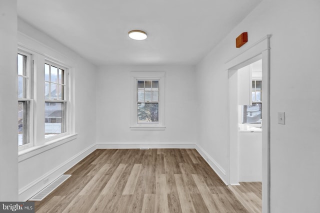 unfurnished room with light wood-type flooring