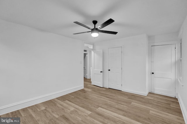 unfurnished bedroom with ceiling fan and light wood-type flooring