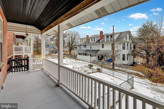 view of snow covered back of property