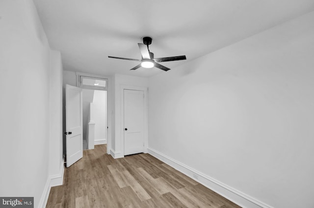 unfurnished bedroom with ceiling fan and light wood-type flooring