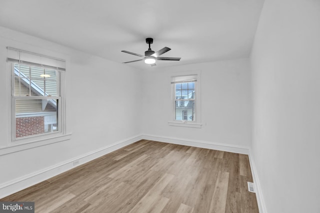 empty room featuring ceiling fan and light hardwood / wood-style flooring