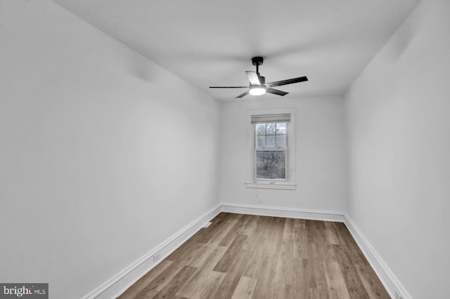 spare room featuring light hardwood / wood-style floors and ceiling fan