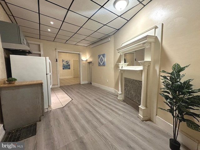 living room with light wood-type flooring and a drop ceiling