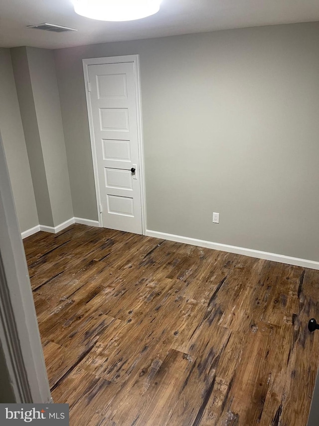 unfurnished room with hardwood / wood-style floors