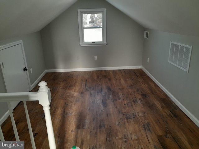 bonus room featuring lofted ceiling and dark hardwood / wood-style floors