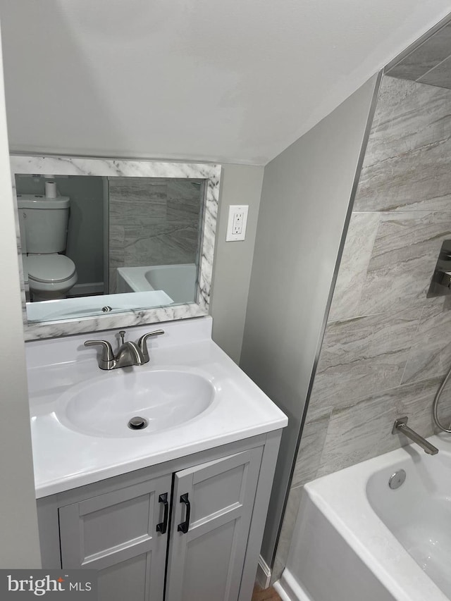 bathroom featuring vanity and toilet