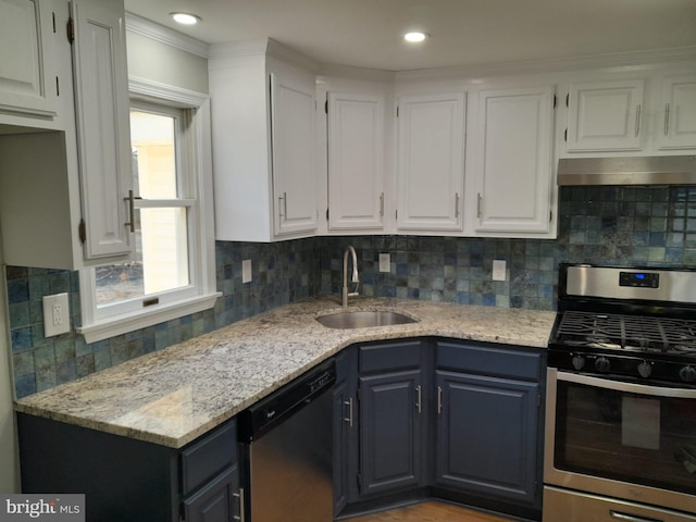 kitchen with white cabinetry, appliances with stainless steel finishes, sink, and decorative backsplash