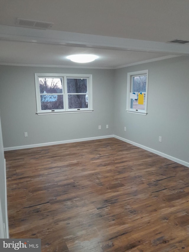 unfurnished room featuring crown molding and dark hardwood / wood-style flooring