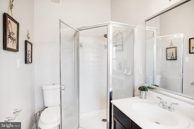 bathroom featuring walk in shower, vanity, and toilet