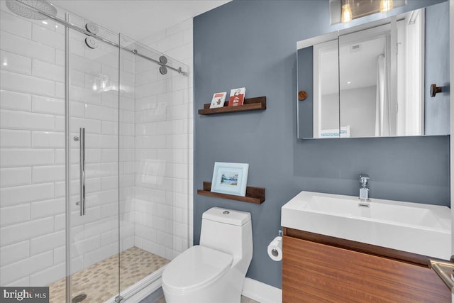 bathroom featuring vanity, an enclosed shower, and toilet