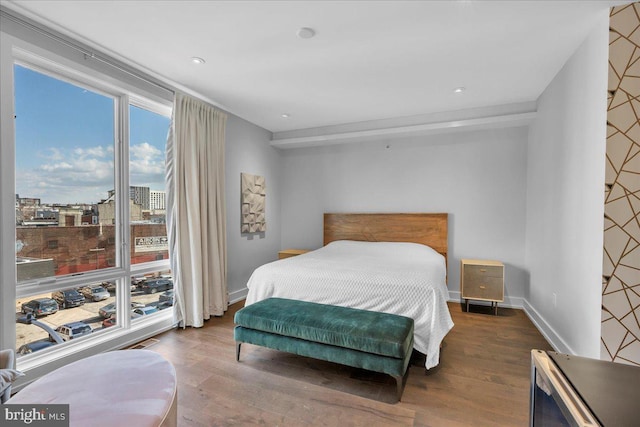 bedroom with dark wood-type flooring