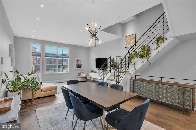 dining room with an inviting chandelier and dark hardwood / wood-style floors