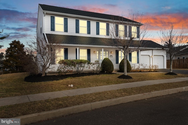 view of front facade with a garage and a lawn