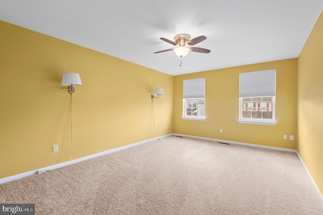 unfurnished room with ceiling fan and carpet flooring