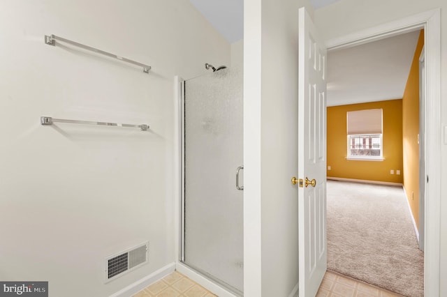 bathroom featuring a shower with shower door