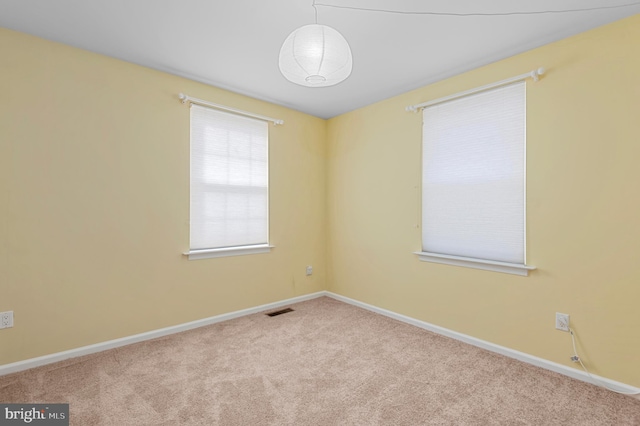 unfurnished room with light colored carpet