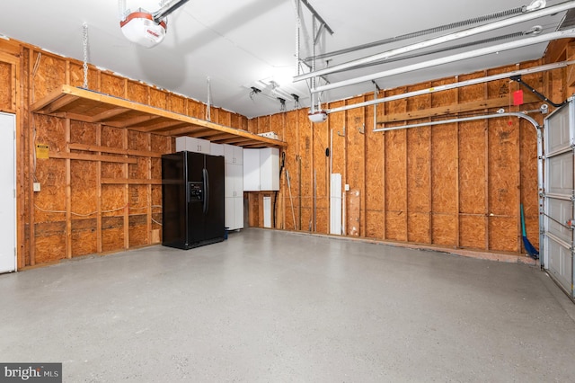 garage featuring a garage door opener and black fridge with ice dispenser