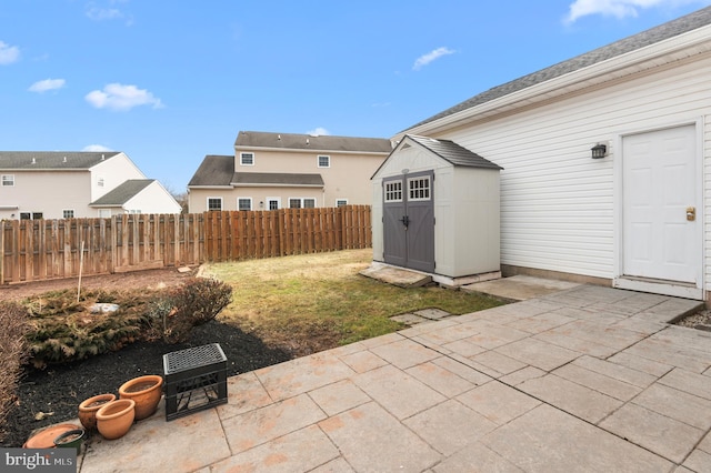 view of yard featuring a patio area and a storage unit