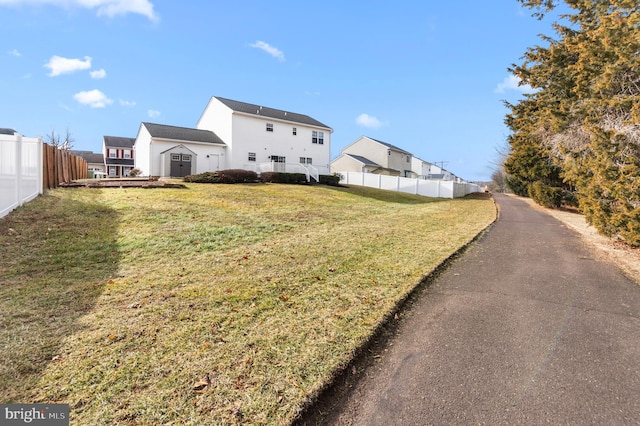 rear view of property featuring a lawn