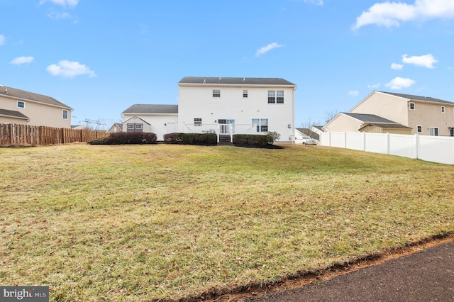 rear view of house with a lawn