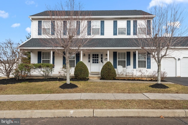 view of front facade featuring a garage, a porch, and a front lawn