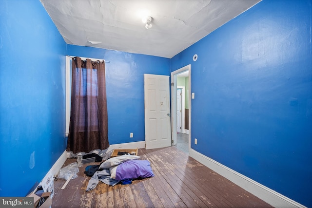 unfurnished bedroom with hardwood / wood-style flooring