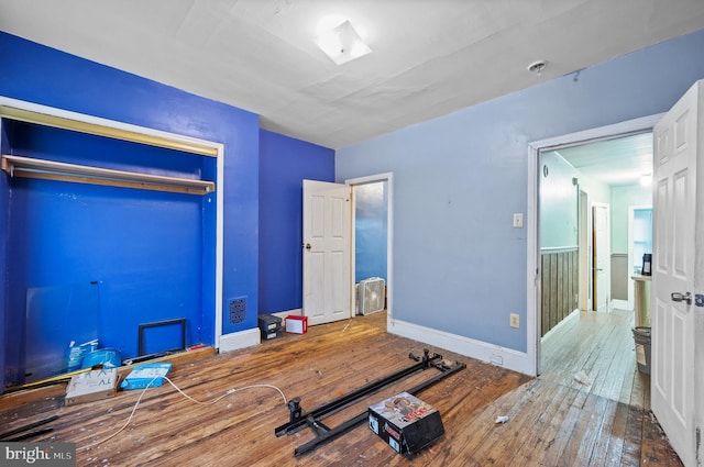 bedroom with hardwood / wood-style floors and a closet