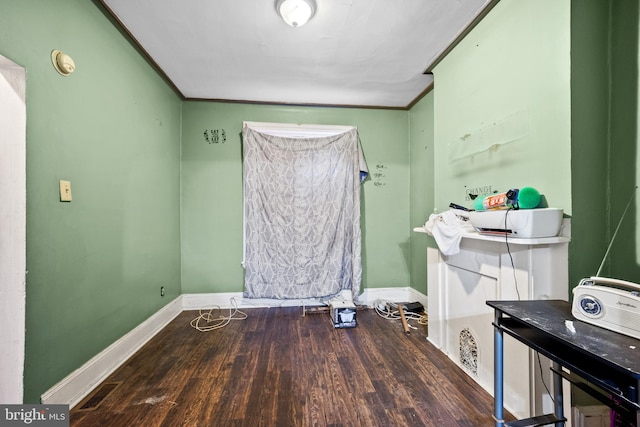 bathroom with ornamental molding and wood-type flooring