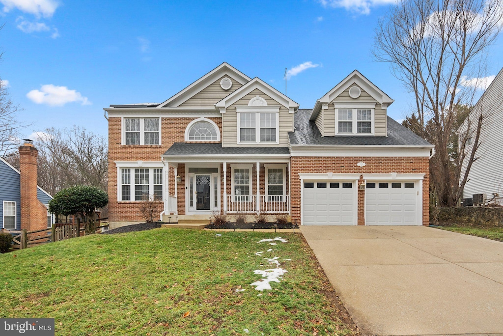 view of front of property featuring concrete driveway, a porch, a front yard, and brick siding