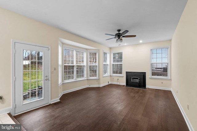 unfurnished living room with wood-type flooring and ceiling fan