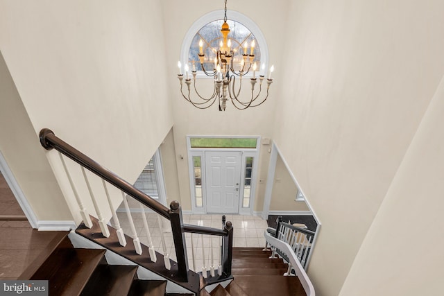 entryway with a high ceiling and a chandelier