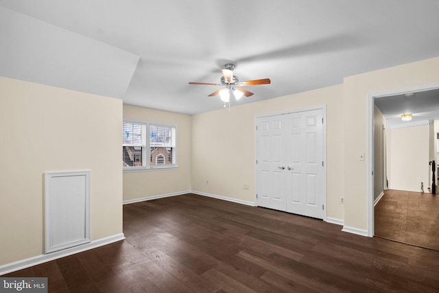 unfurnished bedroom with ceiling fan, dark hardwood / wood-style floors, and a closet