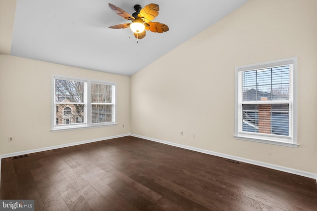 empty room featuring lofted ceiling, dark wood-type flooring, and ceiling fan