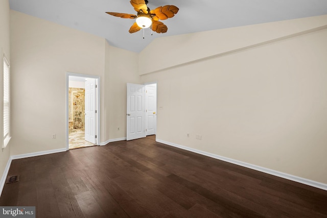 unfurnished bedroom with dark wood-type flooring, high vaulted ceiling, and ensuite bathroom