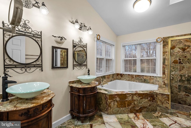 bathroom with vanity, vaulted ceiling, and separate shower and tub