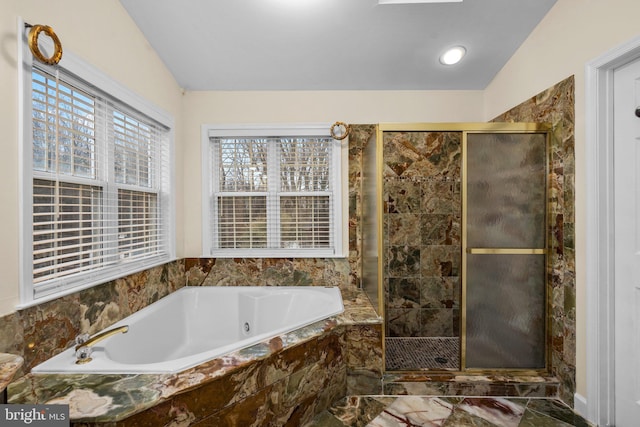 bathroom featuring shower with separate bathtub and vaulted ceiling