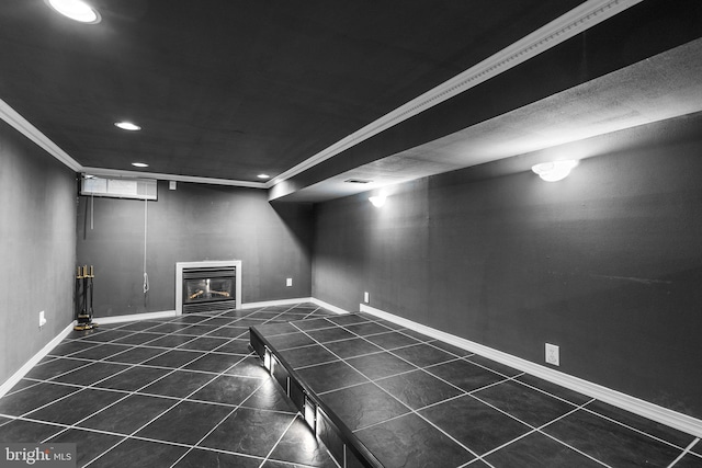 basement with ornamental molding and dark tile patterned floors