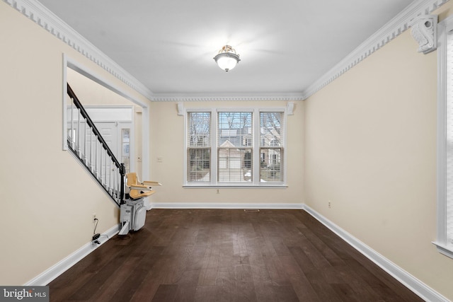 interior space featuring crown molding and dark wood-type flooring