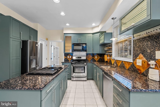 kitchen with tasteful backsplash, sink, hanging light fixtures, light tile patterned floors, and black appliances