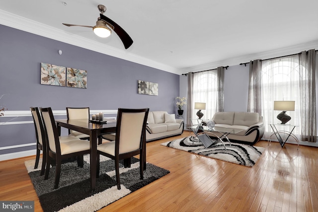 dining area featuring crown molding, ceiling fan, and light wood-type flooring