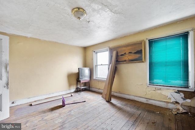 interior space with hardwood / wood-style floors and a textured ceiling