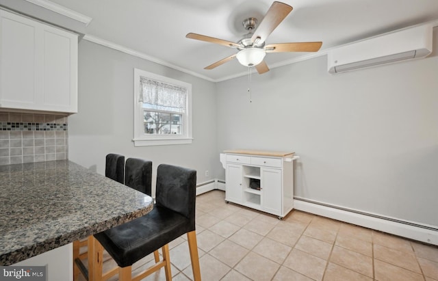 tiled dining space with a wall mounted air conditioner, ornamental molding, ceiling fan, and baseboard heating