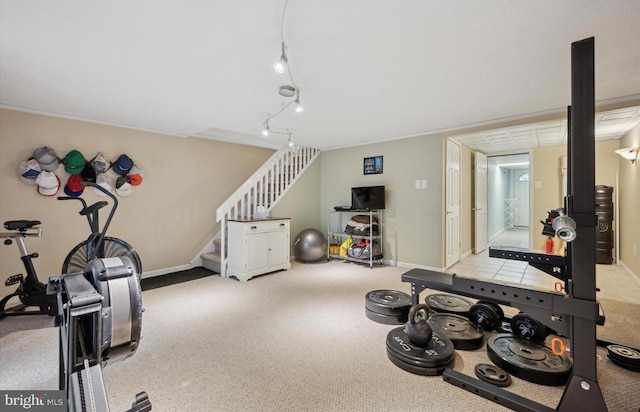 workout room with rail lighting and light colored carpet